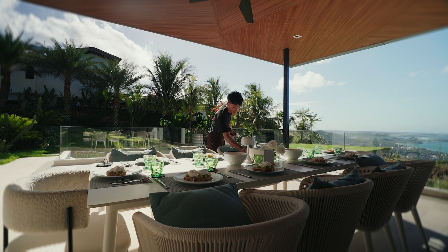 A private chef preparing a meal at a holiday home dining table